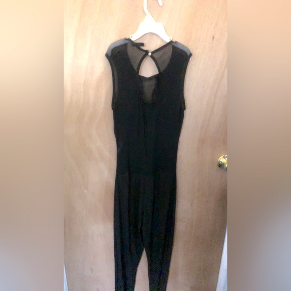 All black jumpsuit with sheer cross on chest, and sheer back out